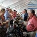 Wine suppliers at the Grand Wine Tasting interact with guests