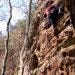 A rock climber makes his way to the top.