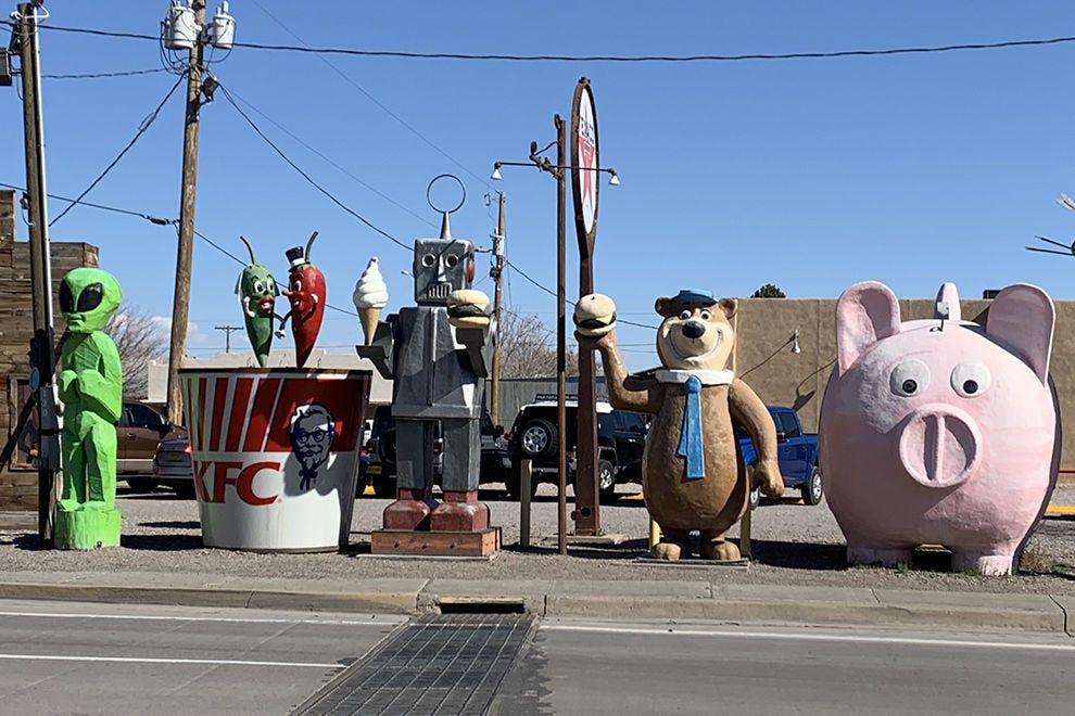 A cast of giant characters lines up across the street from Sparky's calling attention to the burger joint