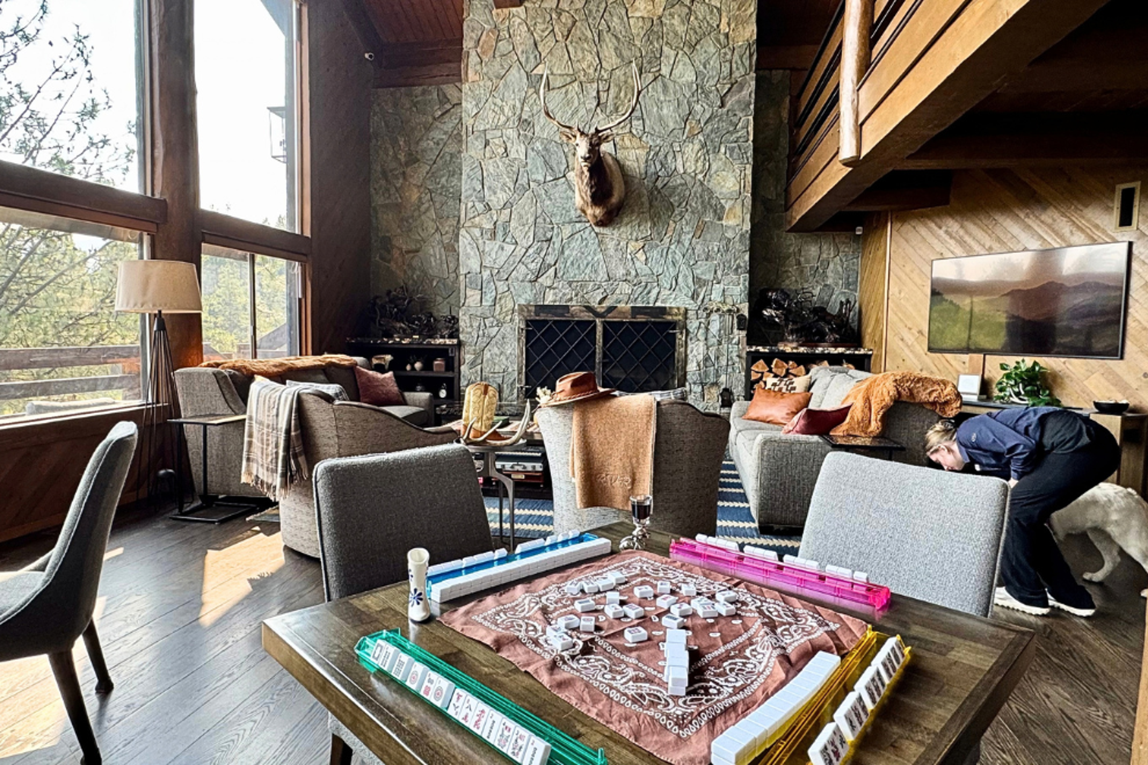 Travel writer Ava Roxanne Stritt photographed playing mahjong at a table at River View Ranch. 